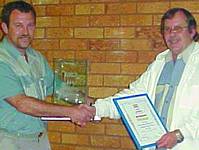 Tony Vis (right) presenting Danie Pieters from Yokogawa with the Trophy